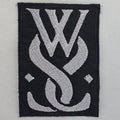 Patch While She - logo - Metalvest