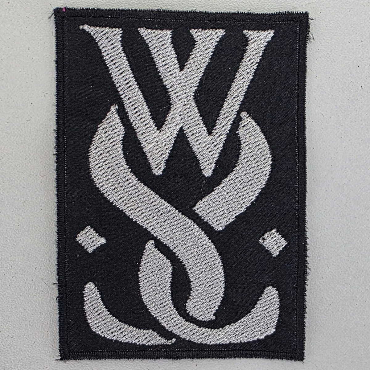 Patch While She - logo - Metalvest